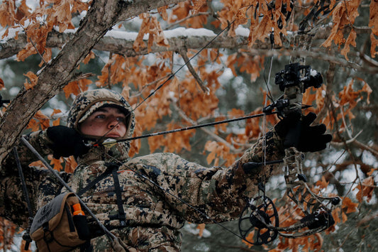 Bow hunting in low light Adjustable Red Dot, a bow hunter shooting in the winter. 